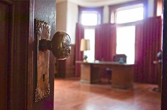 Picture of a doorknob leading into an office
